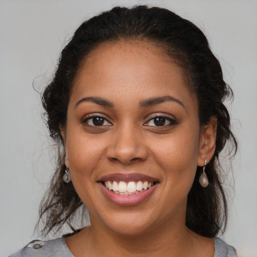 Joyful latino young-adult female with medium  brown hair and brown eyes