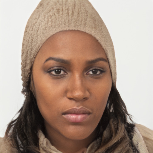 Joyful black young-adult female with long  brown hair and brown eyes