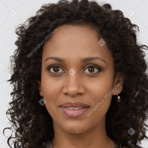 Joyful black young-adult female with long  brown hair and brown eyes