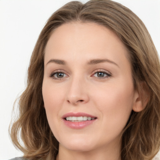 Joyful white young-adult female with long  brown hair and blue eyes