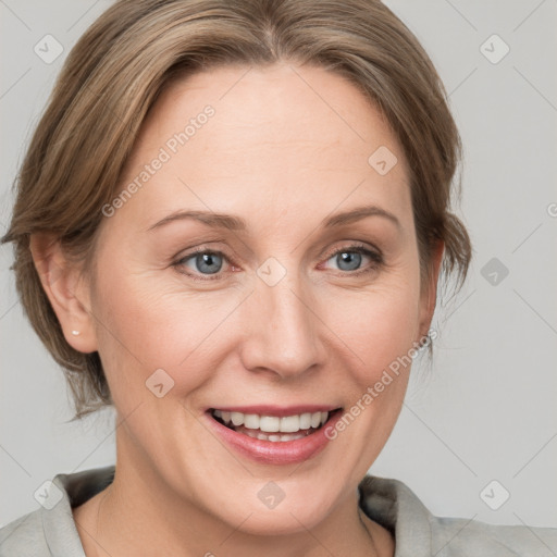 Joyful white adult female with medium  brown hair and blue eyes