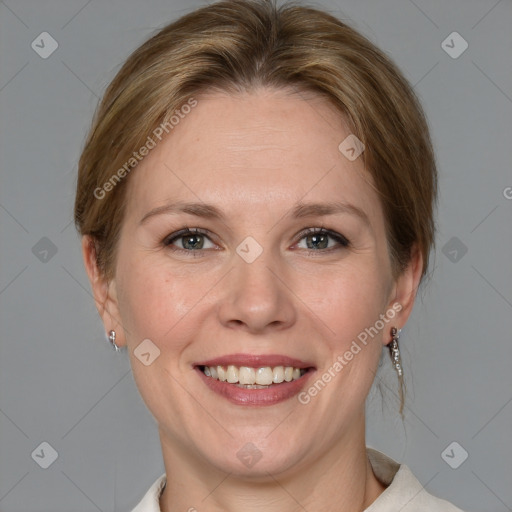 Joyful white adult female with medium  brown hair and blue eyes