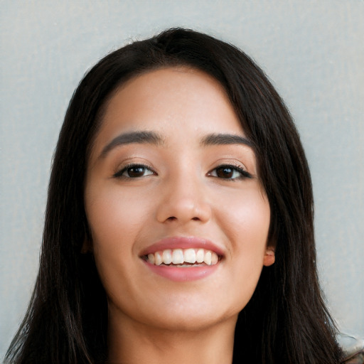 Joyful white young-adult female with long  black hair and brown eyes