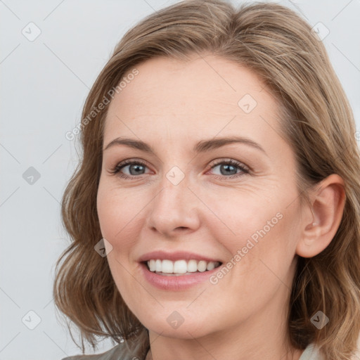 Joyful white young-adult female with medium  brown hair and blue eyes