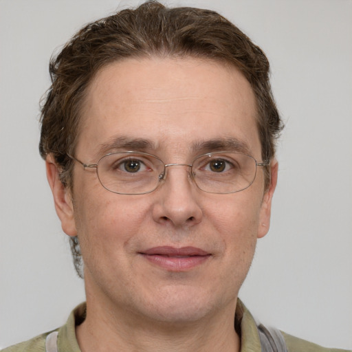 Joyful white adult male with short  brown hair and grey eyes