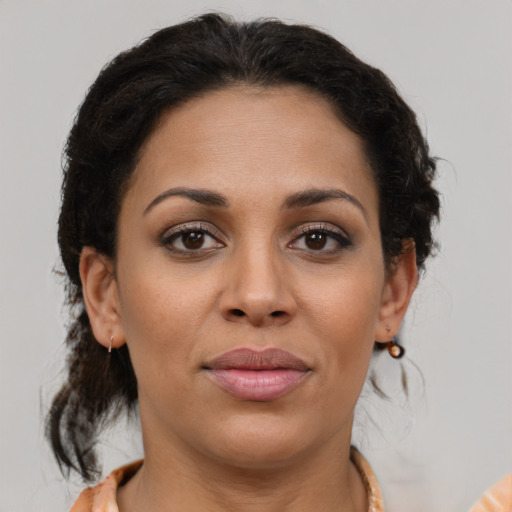 Joyful latino young-adult female with medium  brown hair and brown eyes