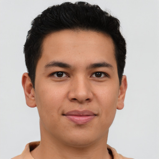 Joyful latino young-adult male with short  brown hair and brown eyes