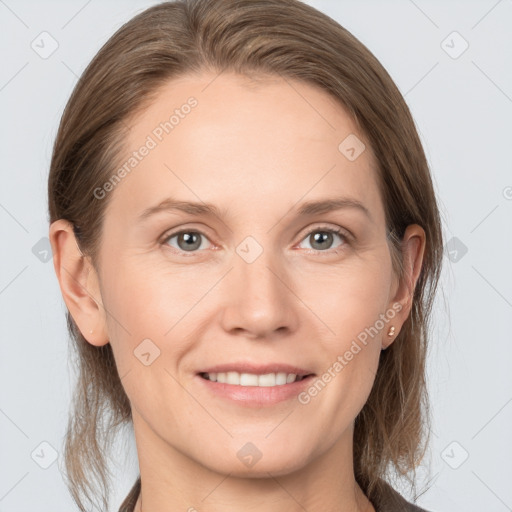 Joyful white young-adult female with medium  brown hair and grey eyes