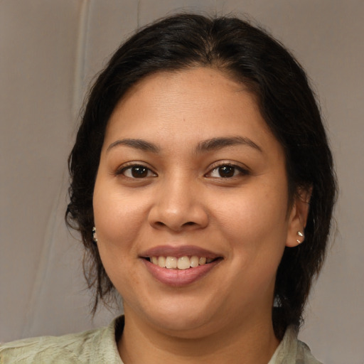 Joyful latino young-adult female with medium  brown hair and brown eyes