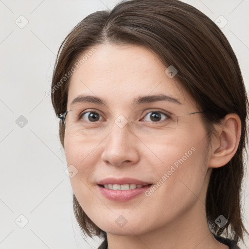 Joyful white young-adult female with medium  brown hair and grey eyes