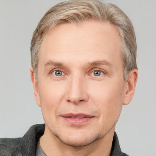 Joyful white adult male with short  brown hair and grey eyes