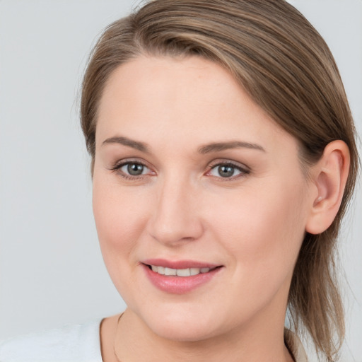 Joyful white young-adult female with medium  brown hair and grey eyes