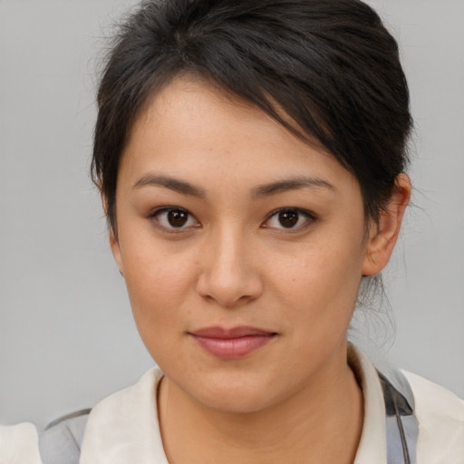 Joyful asian young-adult female with medium  brown hair and brown eyes