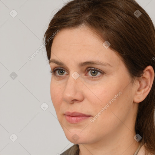 Joyful white adult female with medium  brown hair and grey eyes