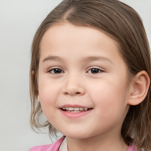 Joyful white child female with medium  brown hair and brown eyes