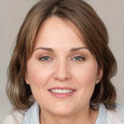 Joyful white young-adult female with medium  brown hair and blue eyes