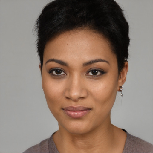 Joyful latino young-adult female with short  black hair and brown eyes