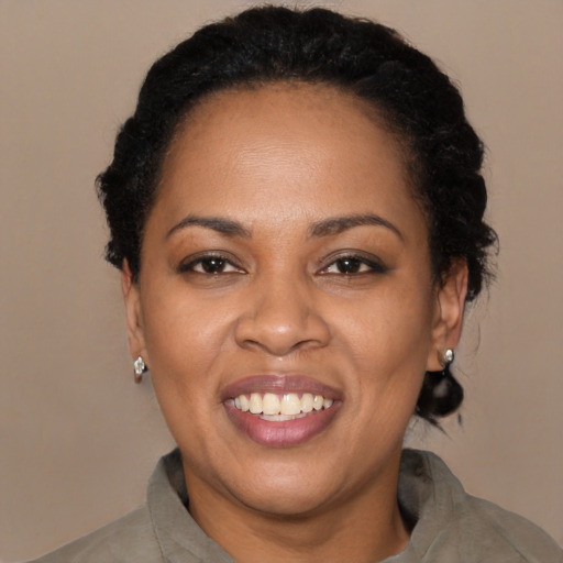 Joyful black adult female with long  black hair and brown eyes