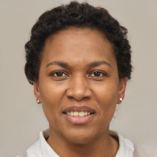 Joyful black adult female with short  black hair and brown eyes
