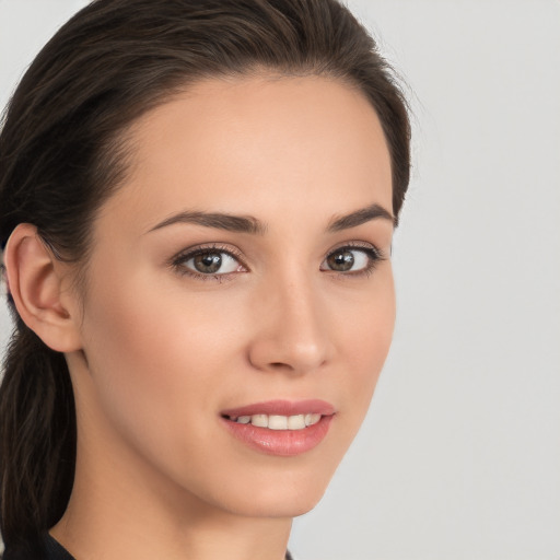 Joyful white young-adult female with long  brown hair and brown eyes