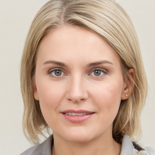 Joyful white young-adult female with medium  brown hair and blue eyes