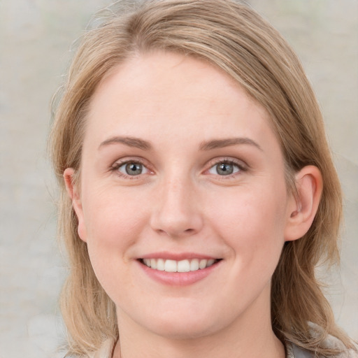 Joyful white young-adult female with medium  brown hair and blue eyes