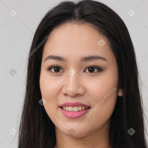 Joyful asian young-adult female with long  brown hair and brown eyes