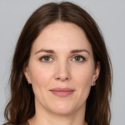 Joyful white adult female with medium  brown hair and brown eyes