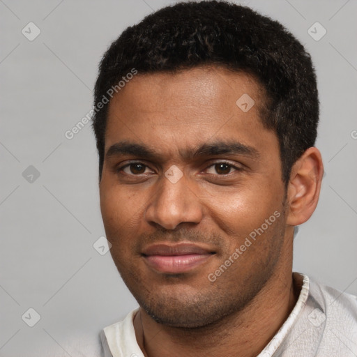 Joyful black young-adult male with short  black hair and brown eyes