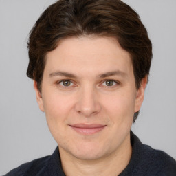 Joyful white adult male with short  brown hair and grey eyes