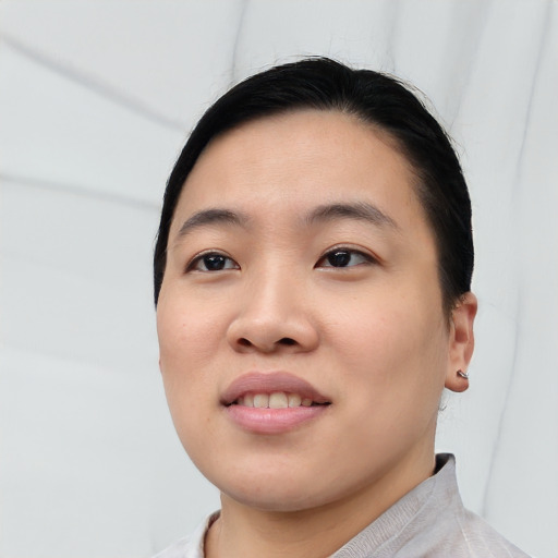 Joyful asian young-adult female with short  black hair and brown eyes