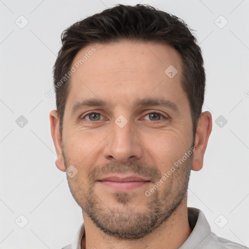 Joyful white adult male with short  brown hair and brown eyes