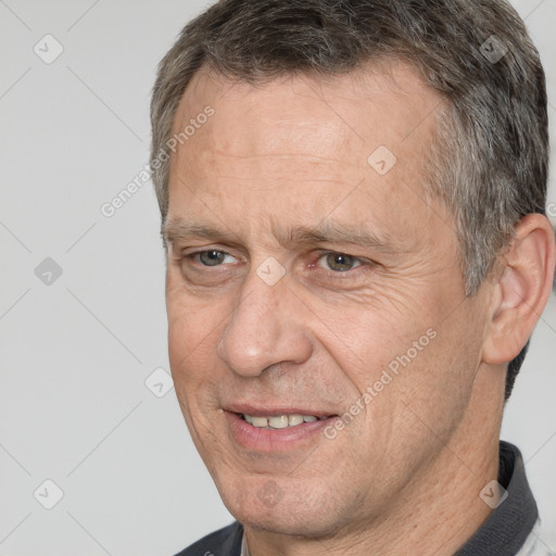 Joyful white middle-aged male with short  brown hair and brown eyes