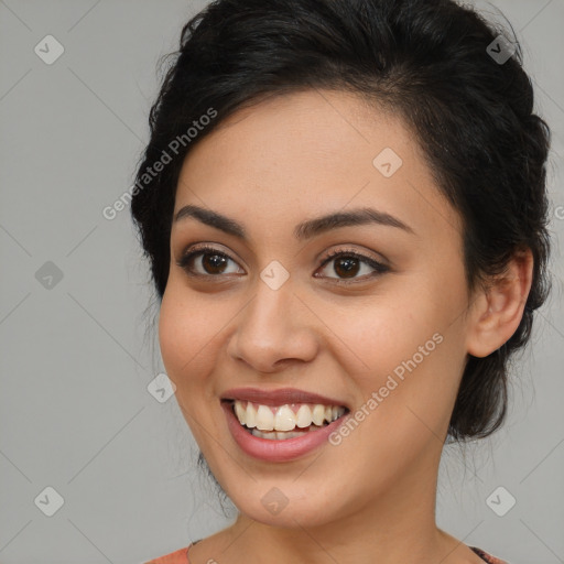 Joyful latino young-adult female with medium  brown hair and brown eyes