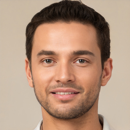 Joyful white young-adult male with short  brown hair and brown eyes