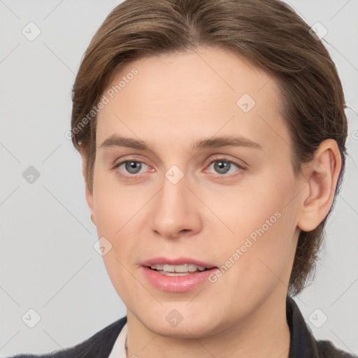 Joyful white young-adult female with medium  brown hair and grey eyes