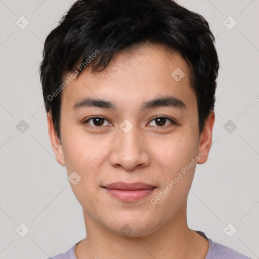 Joyful asian young-adult male with short  black hair and brown eyes