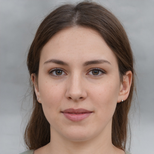 Joyful white young-adult female with medium  brown hair and grey eyes