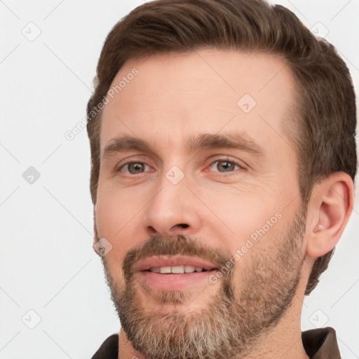 Joyful white adult male with short  brown hair and brown eyes