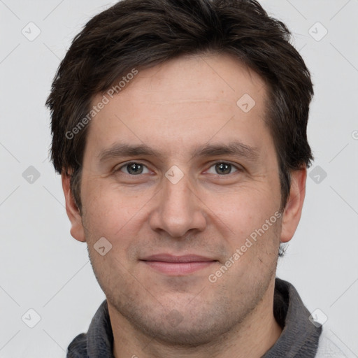 Joyful white adult male with short  brown hair and brown eyes