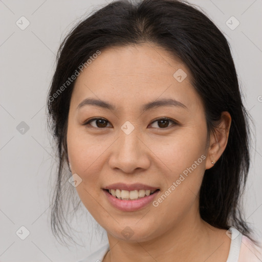 Joyful latino young-adult female with medium  brown hair and brown eyes