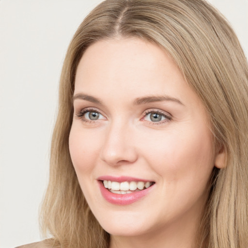 Joyful white young-adult female with long  brown hair and green eyes