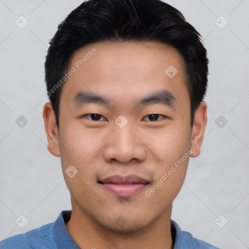 Joyful asian young-adult male with short  black hair and brown eyes