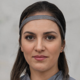 Joyful white young-adult female with medium  brown hair and grey eyes