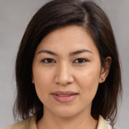 Joyful white young-adult female with medium  brown hair and brown eyes