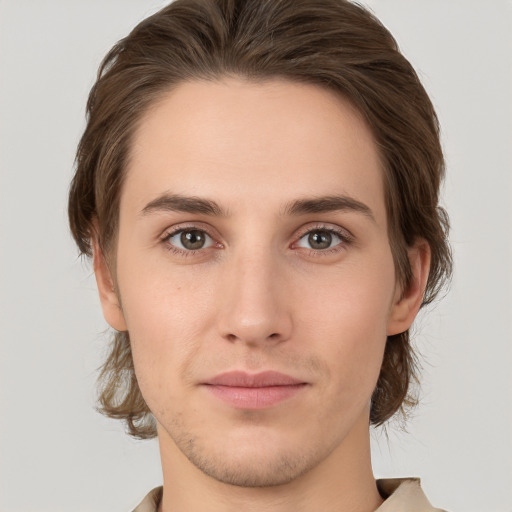 Joyful white young-adult male with medium  brown hair and brown eyes