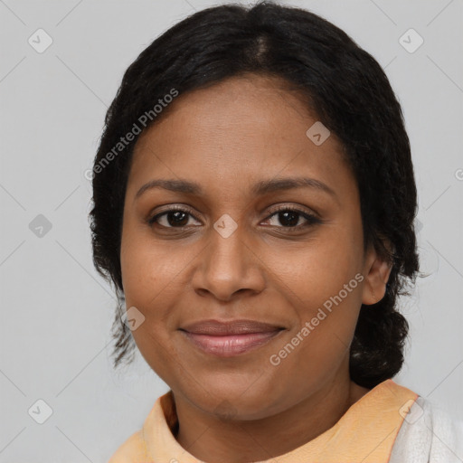 Joyful black adult female with medium  brown hair and brown eyes