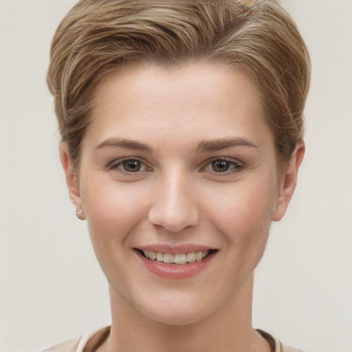 Joyful white young-adult female with short  brown hair and grey eyes