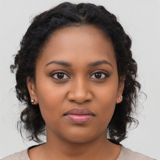 Joyful black young-adult female with medium  black hair and brown eyes