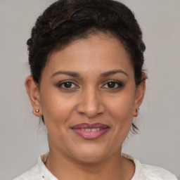 Joyful latino young-adult female with short  brown hair and brown eyes